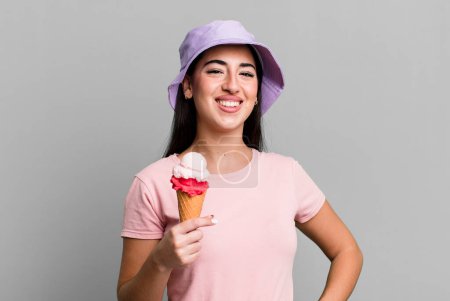 Foto de Smiling happily with a hand on hip and confident. ice cream and summer concept - Imagen libre de derechos