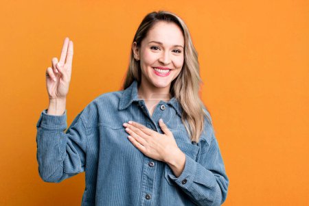 Photo for Looking happy, confident and trustworthy, smiling and showing victory sign, with a positive attitude - Royalty Free Image
