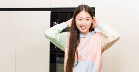 Foto de Asian pretty woman at new home kitchen - Imagen libre de derechos