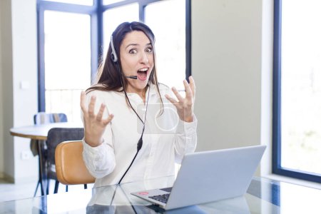 Photo for Young pretty woman feeling extremely shocked and surprised. telemarketer concept - Royalty Free Image