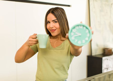 Foto de Bonita mujer latina tomando una taza de café en casa. - Imagen libre de derechos