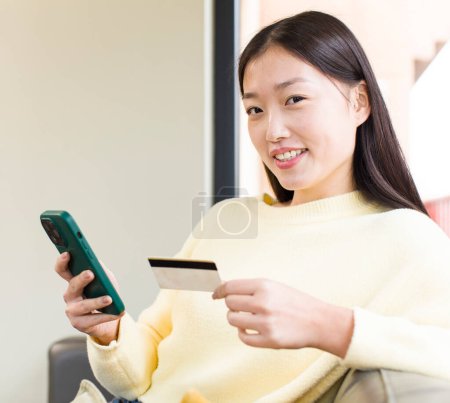 Foto de Asian pretty woman using a smartphone and shopping at home - Imagen libre de derechos