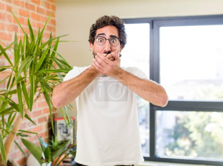 Foto de Young adult crazy man with expressive pose at a modern house interior - Imagen libre de derechos