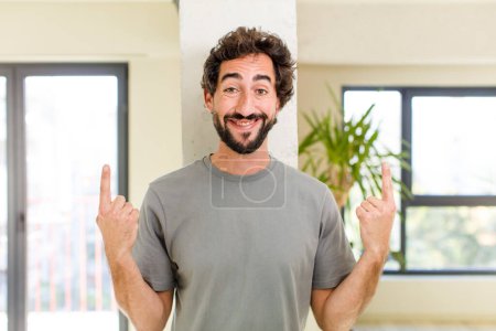 Photo for Young adult crazy man with expressive pose at a modern house interior - Royalty Free Image