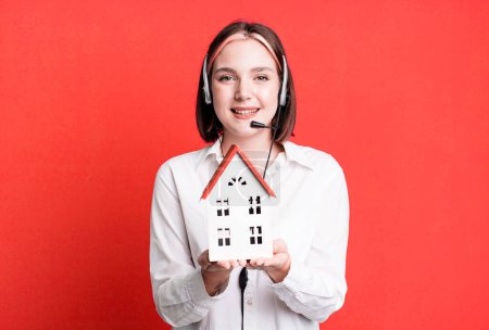 Photo for Young pretty agent woman with a house model. real state concept - Royalty Free Image