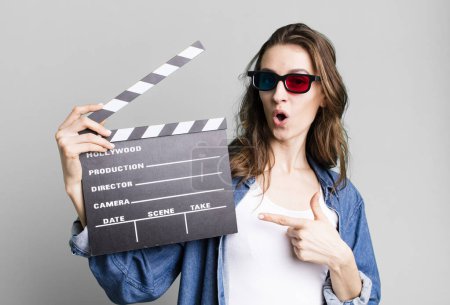 Photo for Young pretty woman holding a clapper cinema board - Royalty Free Image