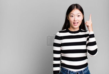 Photo for Pretty asian woman feeling like a happy and excited genius after realizing an idea - Royalty Free Image
