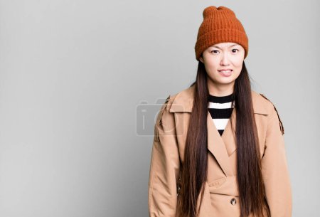 Photo for Pretty asian woman looking puzzled and confused - Royalty Free Image