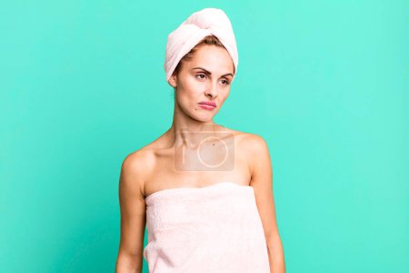 Photo for Hispanic pretty woman feeling sad, upset or angry and looking to the side wearing pbathrobe. beauty concept - Royalty Free Image