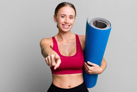 Photo for Caucasian pretty woman pointing at camera choosing you. fitness and yoga concept - Royalty Free Image