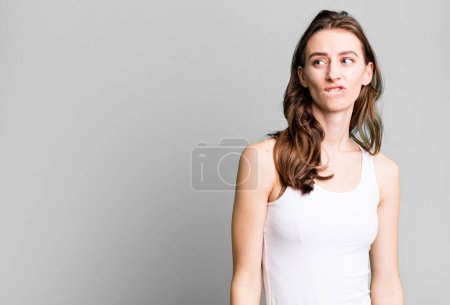 Photo for Young pretty woman looking puzzled and confused - Royalty Free Image
