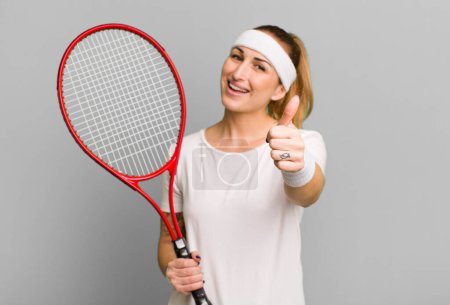 Téléchargez les photos : Young pretty woman feeling proud,smiling positively with thumbs up. tennis concept - en image libre de droit