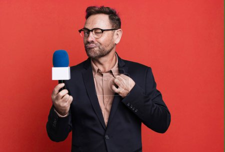 Photo for Middle age man looking arrogant, successful, positive and proud. journalist and a microphone concept - Royalty Free Image