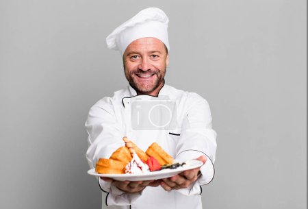 Photo for Middle age man chef concept and waffles sport coach concept with a soccer ball - Royalty Free Image