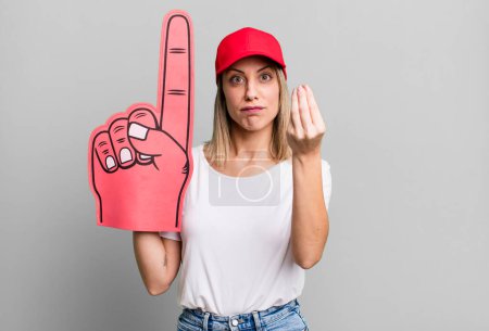 Photo for Pretty blonde woman making capice or money gesture, telling you to pay. number one fan concept - Royalty Free Image