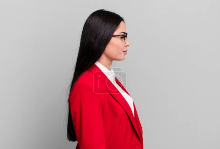 Photo for Hispanic pretty woman on profile view thinking, imagining or daydreaming. business concept - Royalty Free Image