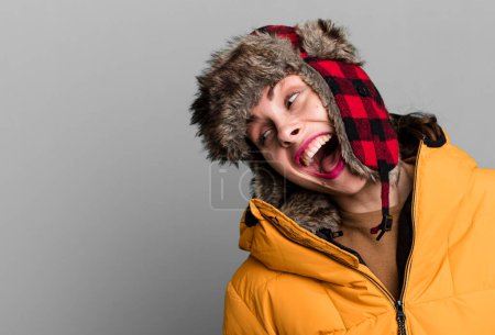 Téléchargez les photos : Young adult pretty woman wearing anorak and winter hat - en image libre de droit