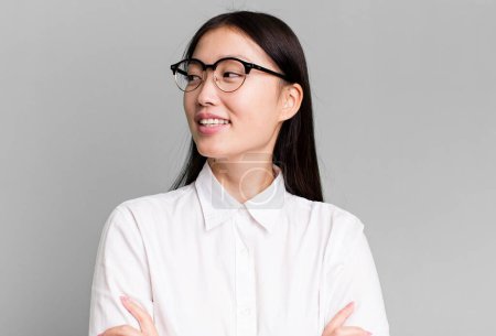 Photo for Young adult pretty asian expressive woman with a copy space to the side - Royalty Free Image