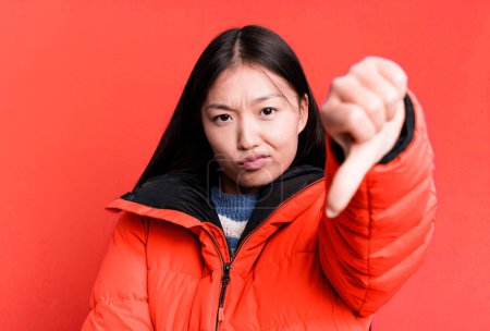 Téléchargez les photos : Young adult pretty asian woman wearing anorak. winter and cold concept - en image libre de droit