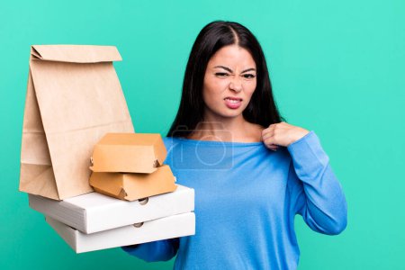 Foto de Hispanic pretty woman feeling stressed, anxious, tired and frustrated. with take away fast food packages - Imagen libre de derechos