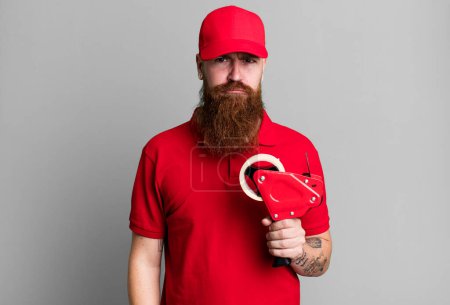Photo for Long beard man feeling sad and whiney with an unhappy look and crying. shipping packer concept - Royalty Free Image