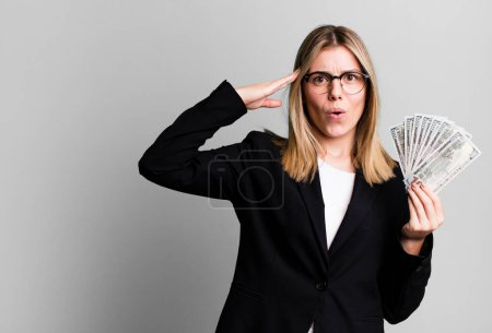 Photo for Young pretty woman looking happy, astonished and surprised. business and money concept - Royalty Free Image