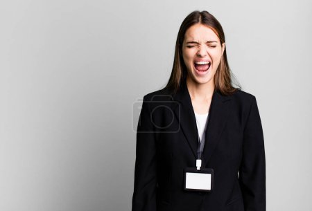 Téléchargez les photos : Young pretty woman shouting aggressively, looking very angry. businesswoman concept - en image libre de droit
