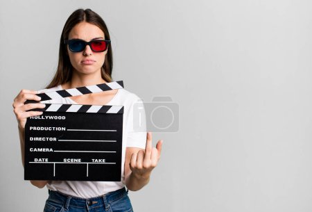 Téléchargez les photos : Young pretty woman feeling angry, annoyed, rebellious and aggressive. cinema film or movie concept - en image libre de droit