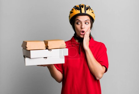Foto de Young pretty woman feeling happy, excited and surprised. pizza delivery concept - Imagen libre de derechos