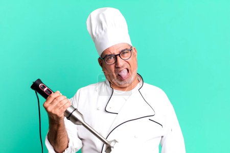 middle age senior man feeling disgusted and irritated and tongue out. restaurant chef with a tool concept