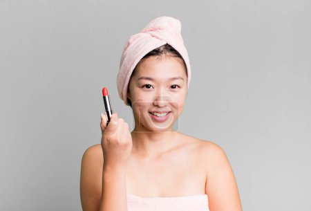 Téléchargez les photos : Young adult pretty asian woman with a lipstick. beauty concept - en image libre de droit