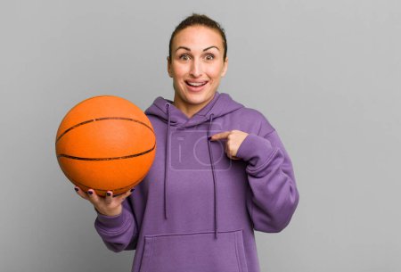 Photo for Young pretty woman feeling happy and pointing to self with an excited. basketball concept - Royalty Free Image