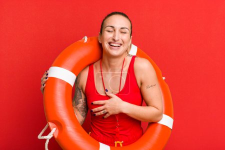 Foto de Young pretty woman laughing out loud at some hilarious joke. summer and lifeguard concept - Imagen libre de derechos
