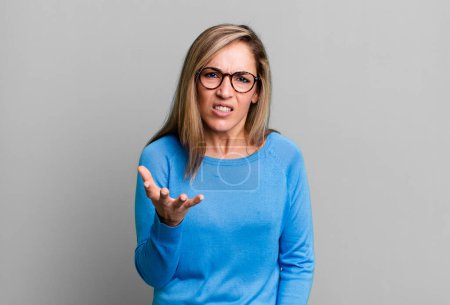 Photo for Blonde adult woman looking angry, annoyed and frustrated screaming wtf or whats wrong with you - Royalty Free Image