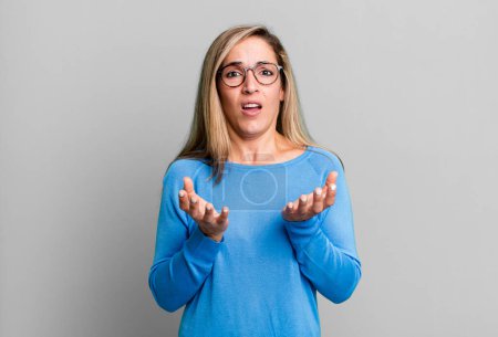 Photo for Blonde adult woman looking desperate and frustrated, stressed, unhappy and annoyed, shouting and screaming - Royalty Free Image