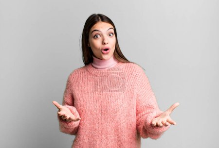 Photo for Pretty young adult woman feeling extremely shocked and surprised, anxious and panicking, with a stressed and horrified look - Royalty Free Image