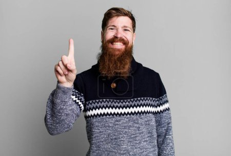 Photo for Long beard and red hair man smiling and looking friendly, showing number one - Royalty Free Image