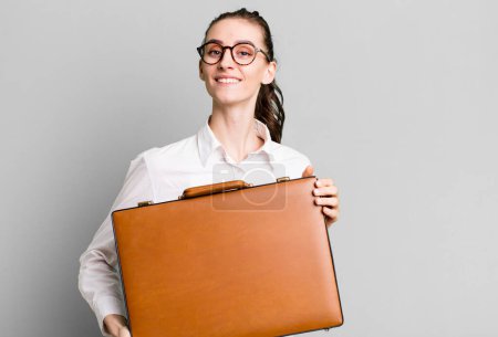 Téléchargez les photos : Jeune jolie femme avec une valise en cuir. concept d'entreprise - en image libre de droit