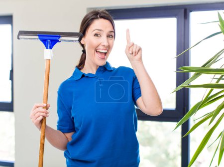 Photo for Young pretty woman feeling like a happy and excited genius after realizing an idea. windows washer concept - Royalty Free Image