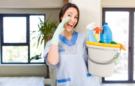 Photo for Young pretty woman feeling happy,giving a big shout out with hands next to mouth. housekeeper concept - Royalty Free Image