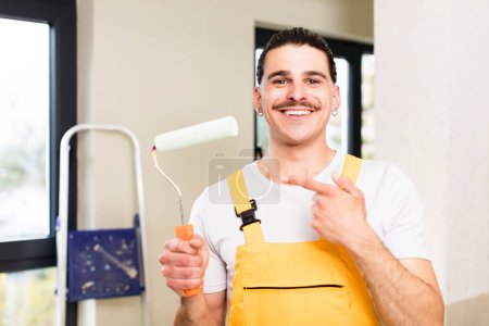Photo for Young handsome man handyman or housekeeper concept at home interior - Royalty Free Image