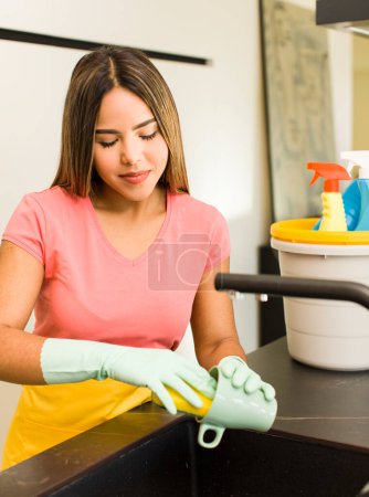Photo for Pretty latin woman. housekeeper with clean products. - Royalty Free Image