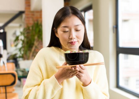 Photo for Asian pretty woman eating a ramen noodles bowl - Royalty Free Image