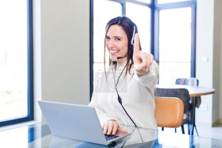 Photo for Young pretty woman smiling proudly and confidently making number one. telemarketer concept - Royalty Free Image