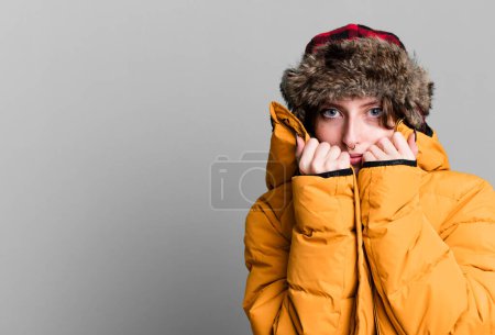 Foto de Caucasian pretty blonde woman wearing anorak and hat. winter and cold concept - Imagen libre de derechos