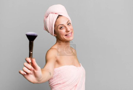 Photo for Young pretty woman wearing bathrobe and making up concept - Royalty Free Image