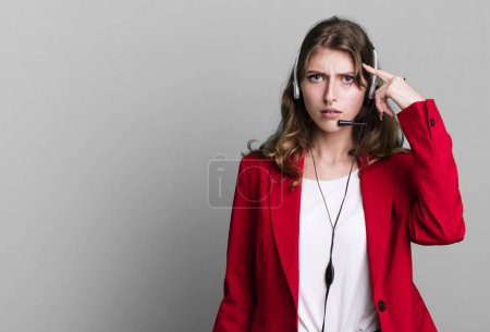 Photo for Caucasian pretty woman feeling confused and puzzled, showing you are insane. telemarketer agent concept - Royalty Free Image