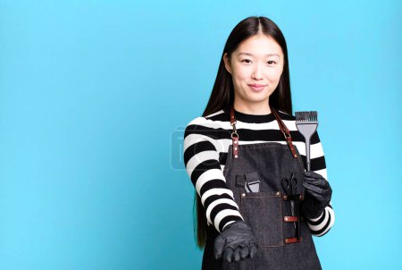 Photo for Pretty asian woman smiling happily with friendly and  offering and showing a concept. barber concept - Royalty Free Image