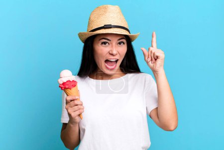 Photo for Hispanic pretty woman feeling like a happy and excited genius after realizing an idea. ice cream and summer concept - Royalty Free Image