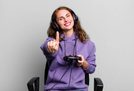 Photo for Hispanic pretty woman smiling proudly and confidently making number one. gamer concept - Royalty Free Image